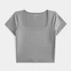 Baby-T-Shirt mit eckigem Ausschnitt aus weichem, nahtlosem Stretch-Stoff Baby-T-Shirt mit eckigem Ausschnitt aus weichem, nahtlosem Stretch-Stoff