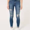 High-Rise-Risse, zerrissene Super Skinny Jeans in mittlerer Waschung High-Rise-Risse, zerrissene Super Skinny Jeans in mittlerer Waschung