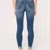 High-Rise-Risse, zerrissene Super Skinny Jeans in mittlerer Waschung High-Rise-Risse, zerrissene Super Skinny Jeans in mittlerer Waschung