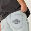 Lockere Jeans mit Downforce Racing-Grafik in heller Waschung Lockere Jeans mit Downforce Racing-Grafik in heller Waschung