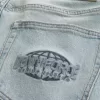 Lockere Jeans mit Downforce Racing-Grafik in heller Waschung Lockere Jeans mit Downforce Racing-Grafik in heller Waschung