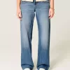 Low-Rise Baggy-Jeans mit mittlerer Waschung und Nietenherzen Low-Rise Baggy-Jeans mit mittlerer Waschung und Nietenherzen