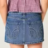 Low-Rise-Mini-Skort aus Denim mit Nieten Low-Rise-Mini-Skort aus Denim mit Nieten