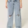 Niedrig geschnittene Baggy-Jeans mit Rissen in mittlerer Waschung Niedrig geschnittene Baggy-Jeans mit Rissen in mittlerer Waschung