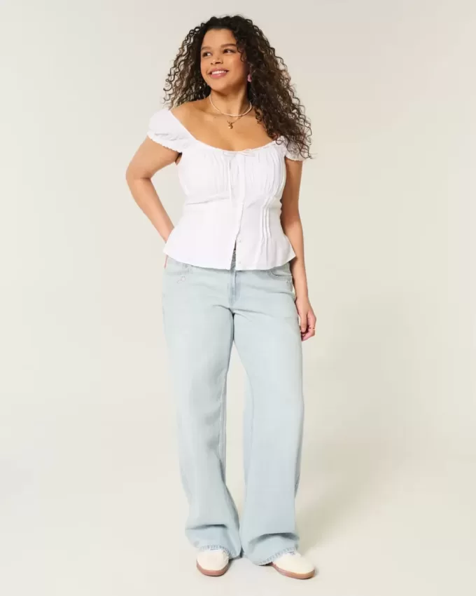 Tief sitzende Baggy-Jeans mit heller Waschung und Sternstickerei Tief sitzende Baggy-Jeans mit heller Waschung und Sternstickerei