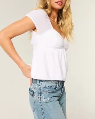 Tief sitzende Baggy-Jeans mit Schmetterlingsgrafik in mittlerer Waschung