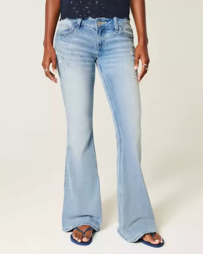 Ultra Low-Rise Distressed Light Wash Flare Jeans mit Pailletten Ultra Low-Rise Distressed Light Wash Flare Jeans mit Pailletten