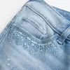 Ultra Low-Rise Distressed Light Wash Flare Jeans mit Pailletten Ultra Low-Rise Distressed Light Wash Flare Jeans mit Pailletten