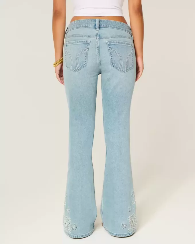 Ultra Low Rise Schlagjeans mit heller Waschung und Blumenstickerei Ultra Low Rise Schlagjeans mit heller Waschung und Blumenstickerei