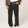 Verwaschene schwarze Baggy-Jeans mit Nieten Verwaschene schwarze Baggy-Jeans mit Nieten
