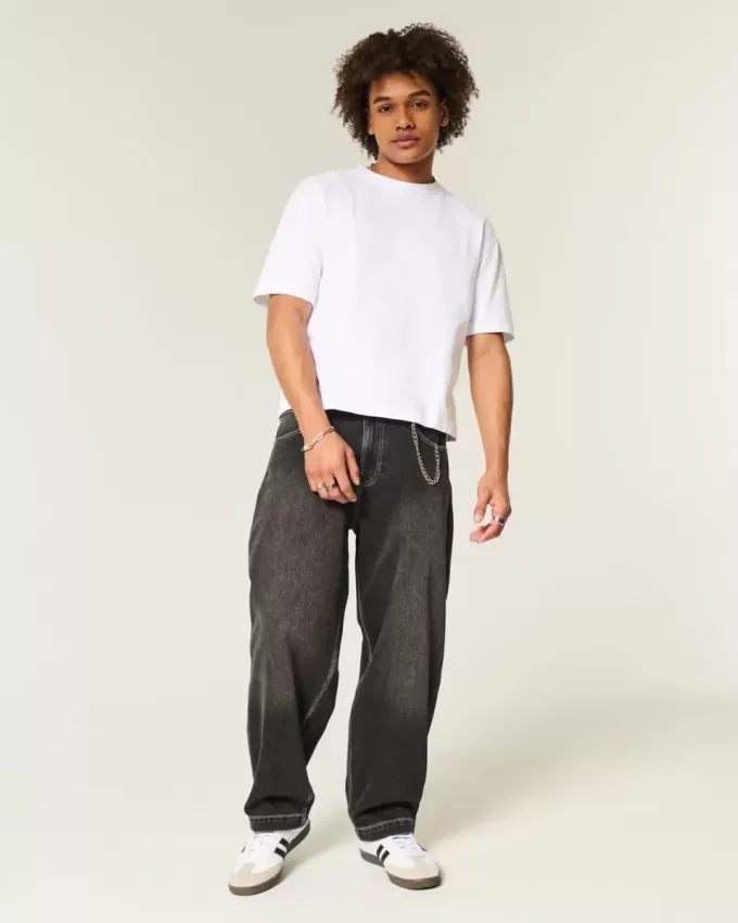 Verwaschene schwarze Skater-Baggy-Jeans mit Schlangenstickerei Verwaschene schwarze Skater-Baggy-Jeans mit Schlangenstickerei