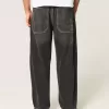 Verwaschene schwarze Skater-Baggy-Jeans mit Schlangenstickerei Verwaschene schwarze Skater-Baggy-Jeans mit Schlangenstickerei