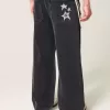Verwaschene schwarze Super Baggy-Jeans mit Sterngrafik Verwaschene schwarze Super Baggy-Jeans mit Sterngrafik