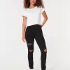 Zerrissene schwarze Jeans-Leggings mit hohem Bund Zerrissene schwarze Jeans-Leggings mit hohem Bund
