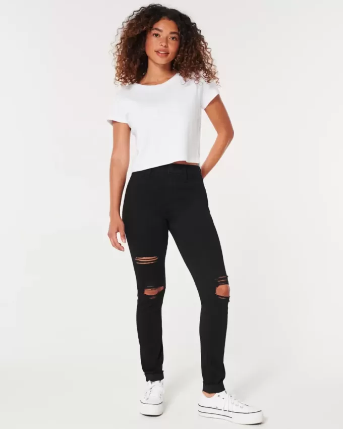 Zerrissene schwarze Jeans-Leggings mit hohem Bund Zerrissene schwarze Jeans-Leggings mit hohem Bund