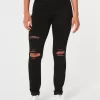 Zerrissene schwarze Jeans-Leggings mit hohem Bund Zerrissene schwarze Jeans-Leggings mit hohem Bund