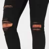 Zerrissene schwarze Jeans-Leggings mit hohem Bund Zerrissene schwarze Jeans-Leggings mit hohem Bund