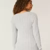 Zopfmuster-Pullover mit V-Ausschnitt und Symbol Zopfmuster-Pullover mit V-Ausschnitt und Symbol